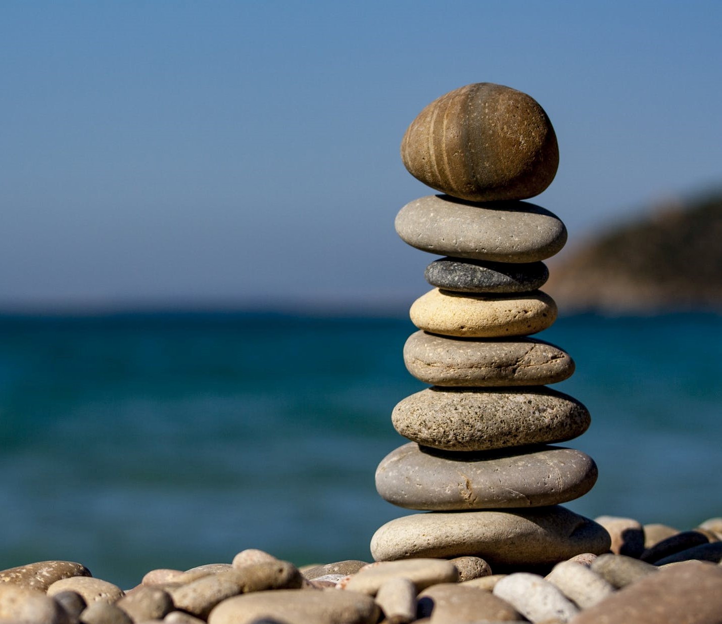 Stacked stones balanced on a rock by the ocean